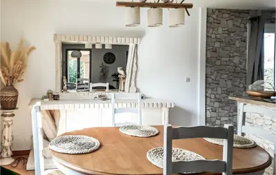 a dining room table with two chairs and a mirror at Amazing Home In Borgo With Kitchen in Borgo