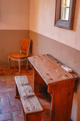 a room with a wooden table and a chair at Casa Sarralonga Di Porto-Vecchio in Porto-Vecchio