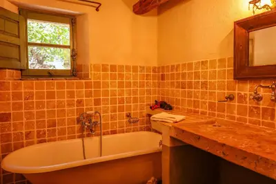 a bathroom with a tub and a sink and a mirror at Casa Sarralonga Di Porto-Vecchio in Porto-Vecchio