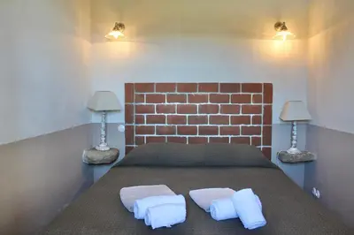 a bedroom with a bed with two pillows on it at Casa Palombaggia Di Porto-Vecchio in Porto-Vecchio