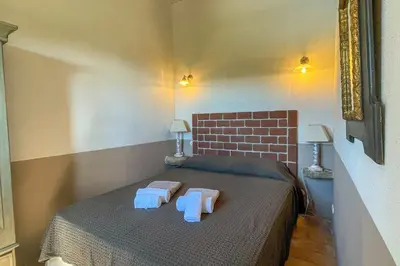 a bedroom with a bed with two towels on it at Casa Palombaggia Di Porto-Vecchio in Porto-Vecchio
