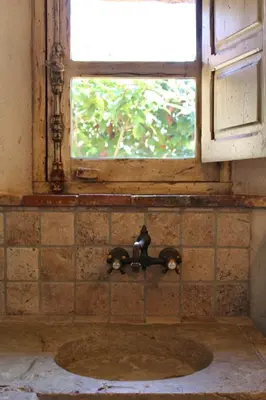 a bathroom with a sink with a window and a tap at Casa Palombaggia Di Porto-Vecchio in Porto-Vecchio