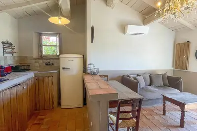 a kitchen and living room with a refrigerator and a couch at Casa Palombaggia Di Porto-Vecchio in Porto-Vecchio
