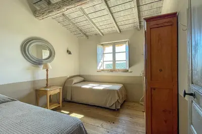 a bedroom with a bed and a mirror and a window at Casa Percale Di Porto-Vecchio in Porto-Vecchio