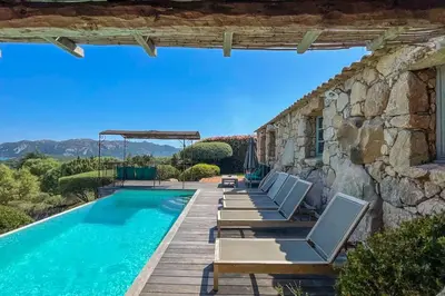 a villa with a swimming pool and lounge chairs at Casa Percale Di Porto-Vecchio in Porto-Vecchio