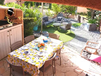 a table with dishes on it on a patio at Maison de Plage à pied San Cipriano 5 pers in Lecci