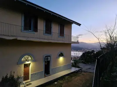 a house with a balcony on the side of it at VILLA BELVEDERE D'AJACCIO, VILLA ENTIERE VUE MER POUR 2 à 10 VOYAGEURS in Ajaccio