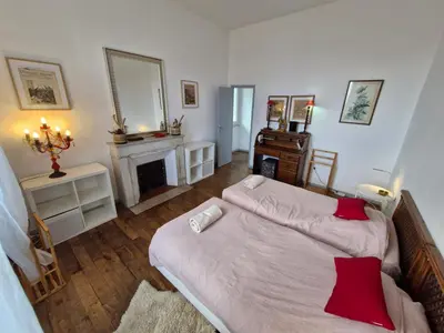 a bedroom with a large bed and a fireplace at VILLA BELVEDERE D'AJACCIO, VILLA ENTIERE VUE MER POUR 2 à 10 VOYAGEURS in Ajaccio