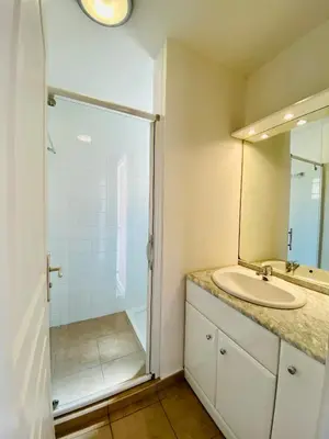 a bathroom with a sink and a shower at A Funtana deux chambres, vue mer, piscine et tennis in Propriano