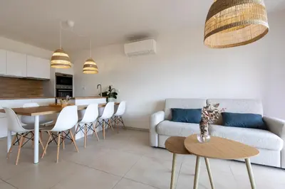 a room with a balcony with a table and chairs at Casa Marina Cargèse in Cargèse