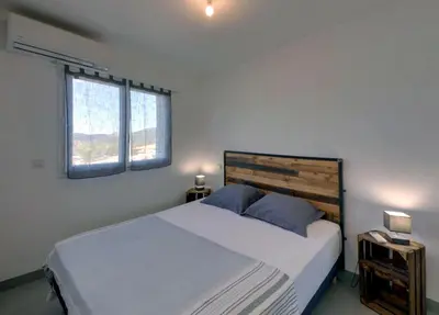 a living room with a couch and a flat screen tv at Villa Orethaga appart Ghjallu in Porto-Vecchio