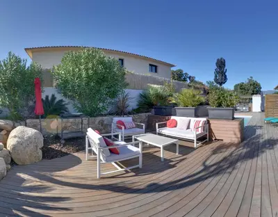 a swimming pool in front of a house at Villa Orethaga appart Ghjallu in Porto-Vecchio