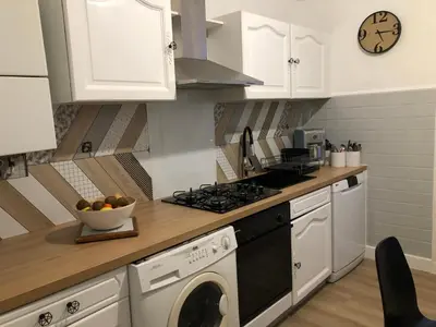 a kitchen with a dishwasher and a stove top oven at Appartement climatisé F3 proche plage port et aéroport in Ajaccio