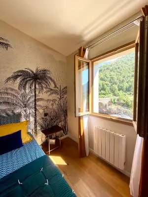 a bedroom with a bed and a large window at CASA VOLTEGIRA in Manso