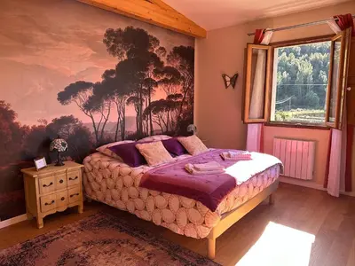 a bedroom with a mural of trees on the wall at CASA VOLTEGIRA in Manso