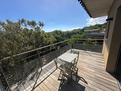 a deck with a bench on top of a house at Villa de luxe surplombant la mer, piscine suspendue in Pianottoli-Caldarello
