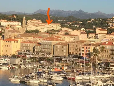 a group of boats docked in a harbor at Jardins de Quatrina in Propriano