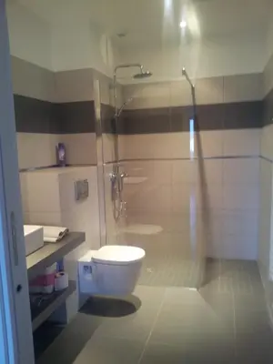 a bathroom with a toilet and a glass shower at Marina d'Oro in Propriano