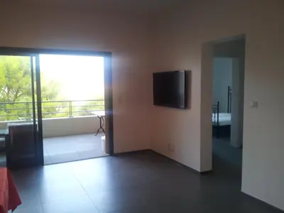 a living room with a flat screen tv on the wall at Marina d'Oro in Propriano