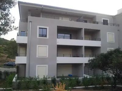 an apartment building with balconies and a parking lot at Marina d'Oro in Propriano