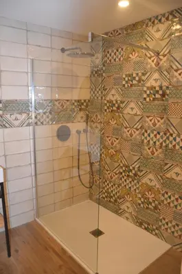 a shower with a glass door in a bathroom at casa funtana d u frusteru in Propriano