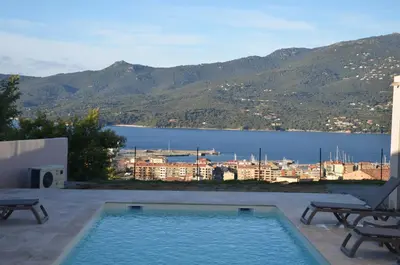 a swimming pool with a view of a city at casa funtana d u frusteru in Propriano