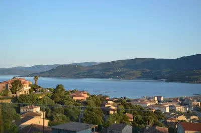 a view of a town and a body of water at casa funtana d u frusteru in Propriano