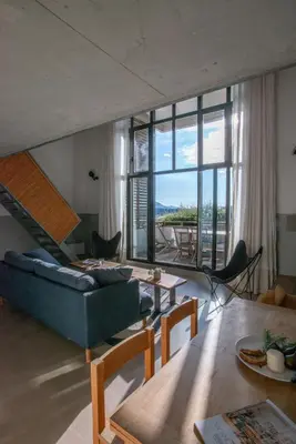 a living room with a couch and a table at Les Salins in Porto-Vecchio