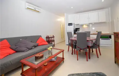 a living room with a couch and a table at 1 Bedroom Lovely Apartment In Propriano in Propriano