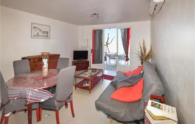 a living room with a couch and a table at 1 Bedroom Lovely Apartment In Propriano in Propriano