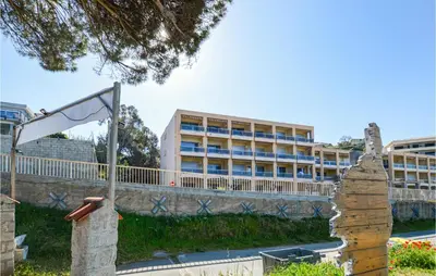a building with a flag in front of a building at 1 Bedroom Lovely Apartment In Propriano in Propriano