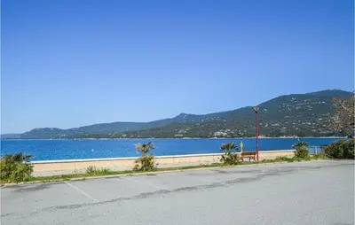 an empty road next to a body of water at 1 Bedroom Lovely Apartment In Propriano in Propriano