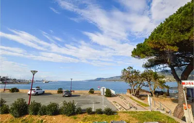 a parking lot next to a large body of water at 1 Bedroom Lovely Apartment In Propriano in Propriano