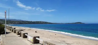 a beach with a row of barriers on the beach at studio 5min plage agosta in Albitreccia