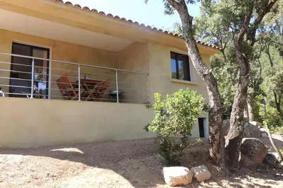 a house with a balcony and a tree at L'Ortu Di Pisettu -2 in Conca