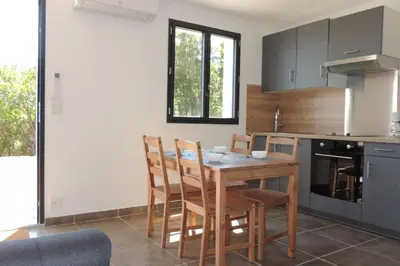 a kitchen with a wooden table and chairs at L'Ortu Di Pisettu -2 in Conca