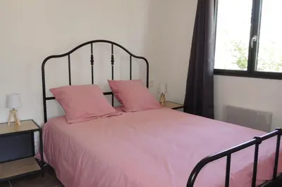 a bedroom with a pink bed with two pink pillows at L'Ortu Di Pisettu -2 in Conca