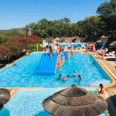 a group of people in a swimming pool at Vacances en Chalet ou Mobil-home chez Camp'in Pirellu in Porto-Vecchio