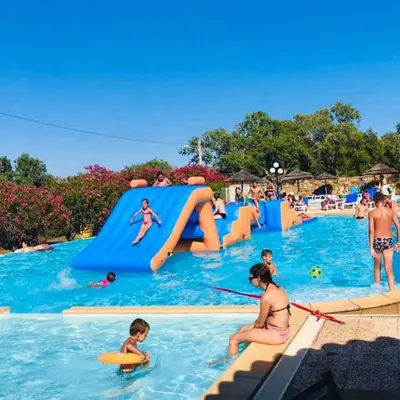 a group of people in the water at a water park at Vacances en Chalet ou Mobil-home chez Camp'in Pirellu in Porto-Vecchio