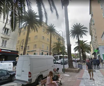 a group of people sitting on a bench next to a van at Toit Terrasse centre historique in Ajaccio