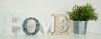 a wooden sign for the word love next to a potted plant at Toit Terrasse centre historique in Ajaccio
