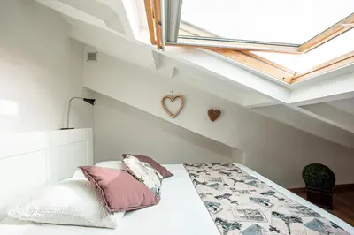 a attic bedroom with a bed with a skylight at Toit Terrasse centre historique in Ajaccio