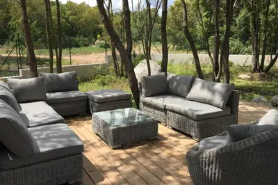 a patio with couches and chairs and a table at Villa Tinuta 8 pers piscine chauffée 5 min plage en voiture in Sainte-Lucie de Porto-Vecchio