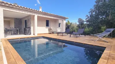 a bed with two pillows on top of it at Villa Salute 6 pers 5 min plage en voiture in Porto-Vecchio