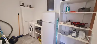 a kitchen with a refrigerator and a washing machine at Appt Bruscaghju 6 pers 10 min rivière à pieds xx 15 min plage en voiture in Sainte-Lucie de Porto-Vecchio