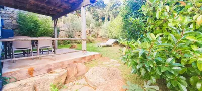a porch of a house with chairs and trees at Appt Bruscaghju 6 pers 10 min rivière à pieds xx 15 min plage en voiture in Sainte-Lucie de Porto-Vecchio