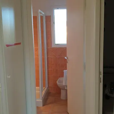 a bathroom with a toilet and a window at Mini villa Messicana 5 pers piscine 500 m plage in Lecci
