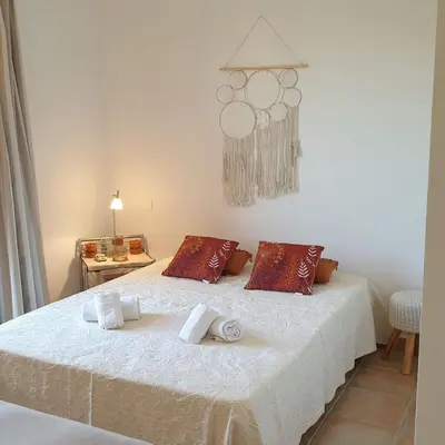 a bedroom with a bed with towels on it at Mini villa Messicana 5 pers piscine 500 m plage in Lecci