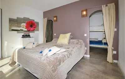 a bedroom with a large bed with towels on it at Awesome Home In Petreto Bicchisano in Petreto-Bicchisano