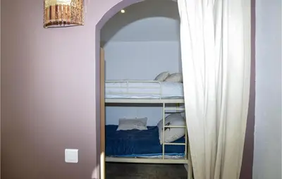 an archway leading to a bunk bed in a room at Awesome Home In Petreto Bicchisano in Petreto-Bicchisano